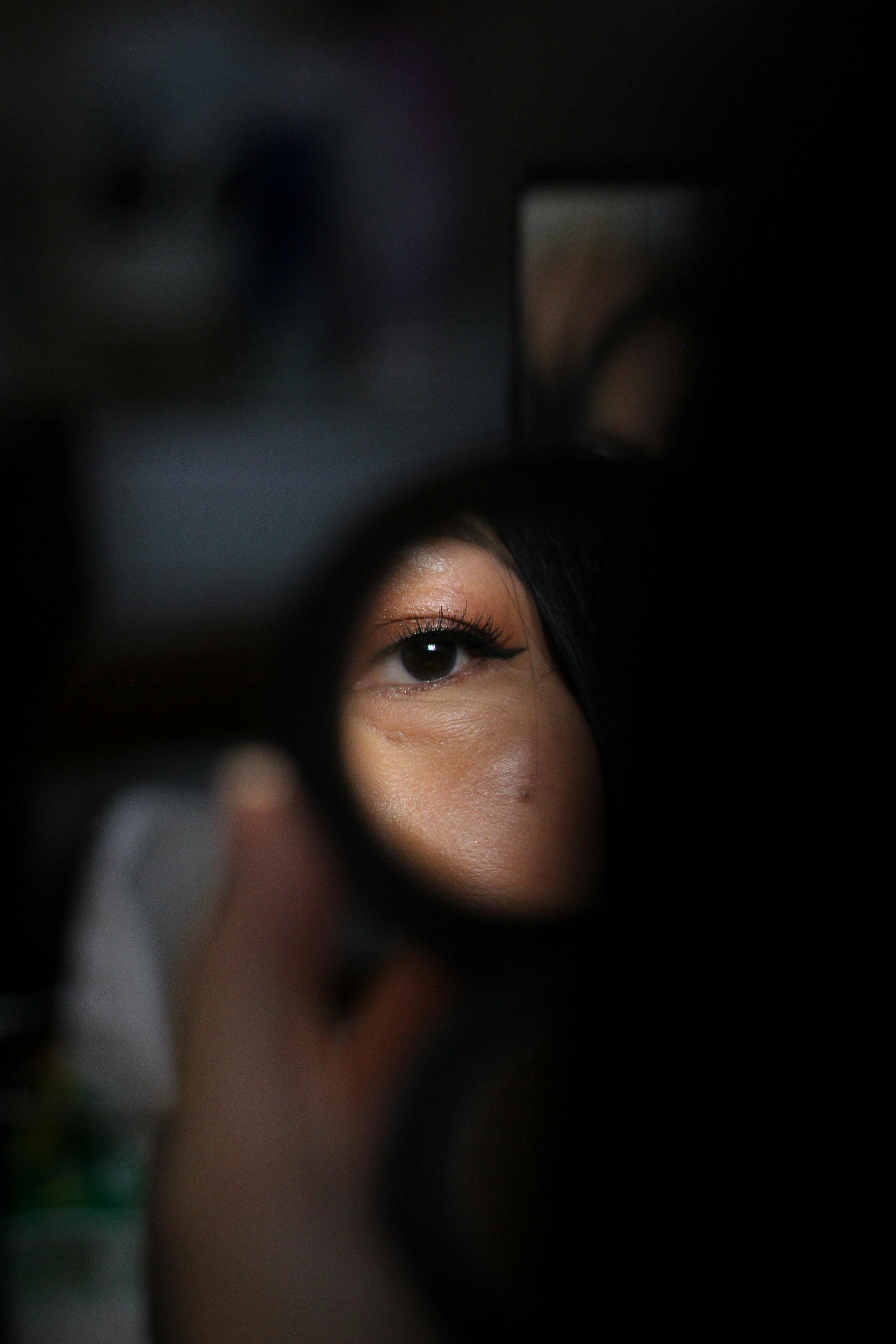 Free Close-up shot of a single eye in a mirror reflection, capturing a detailed Bali moment. Stock Photo