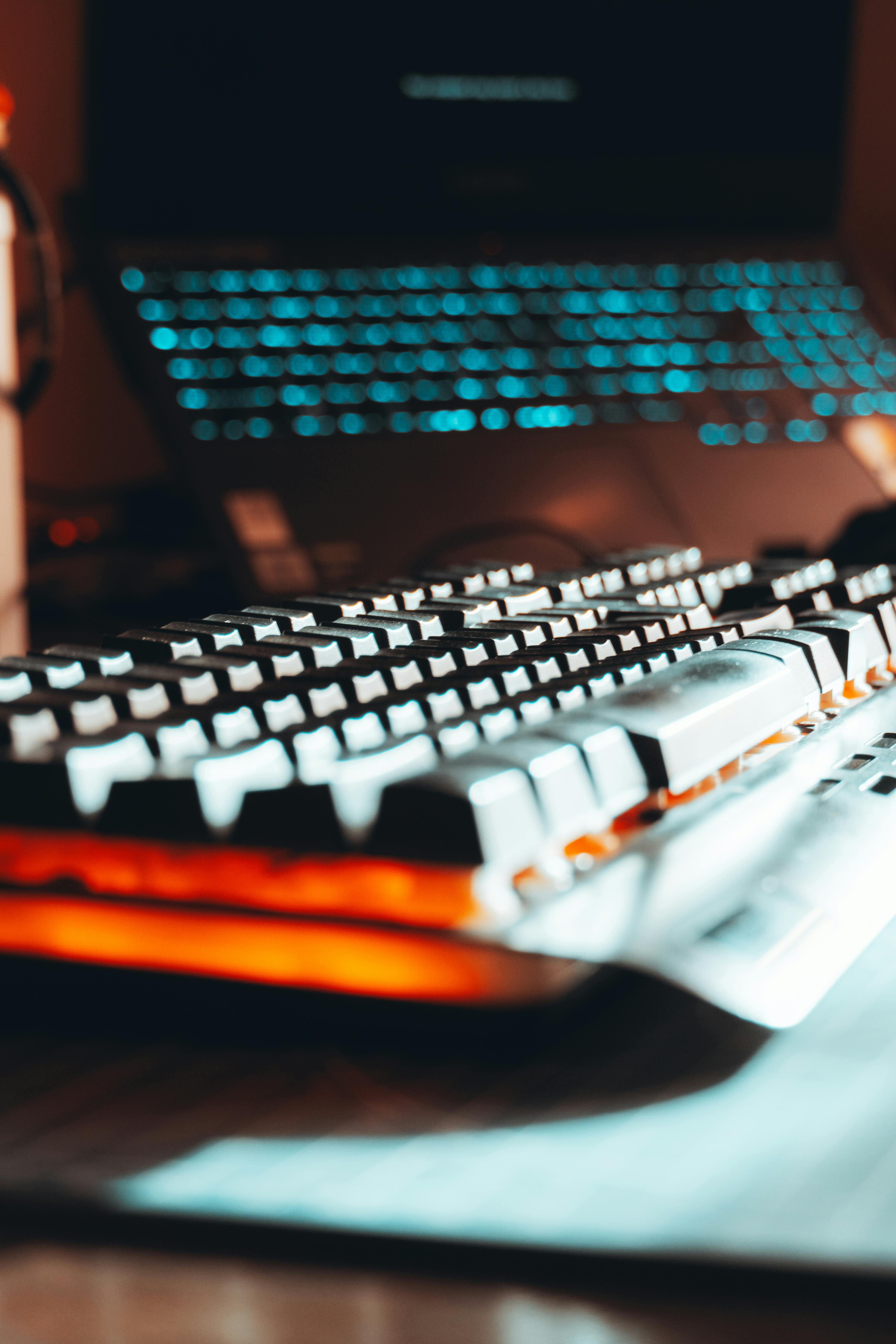 Free Close-up of a backlit keyboard in a dark, moody gaming setup, capturing a tech-inspired ambiance. Stock Photo