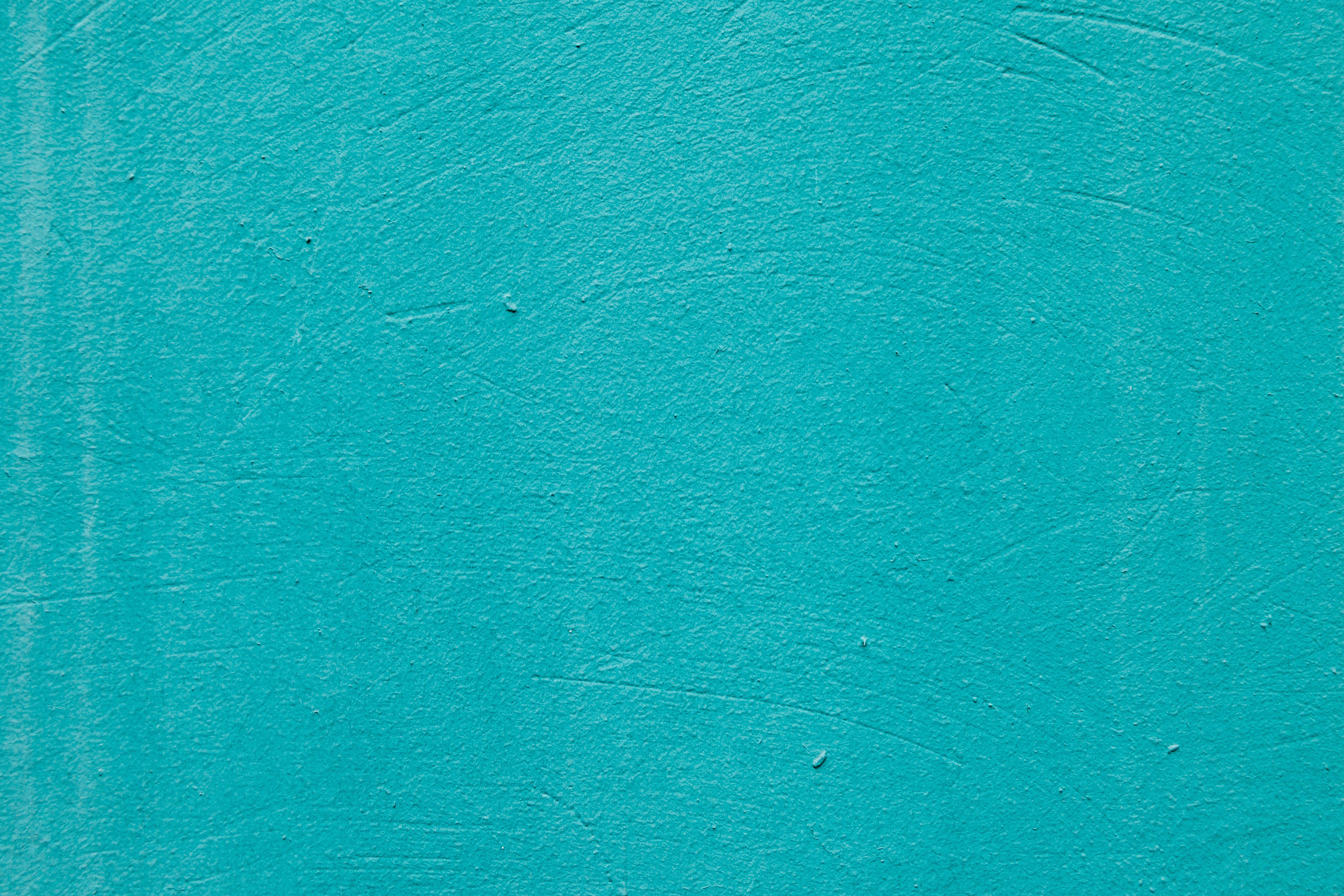 gratis Levendige turquoise achtergrond met textuur, ideaal voor ontwerpdoeleinden en ruimte voor tekst. Stockfoto