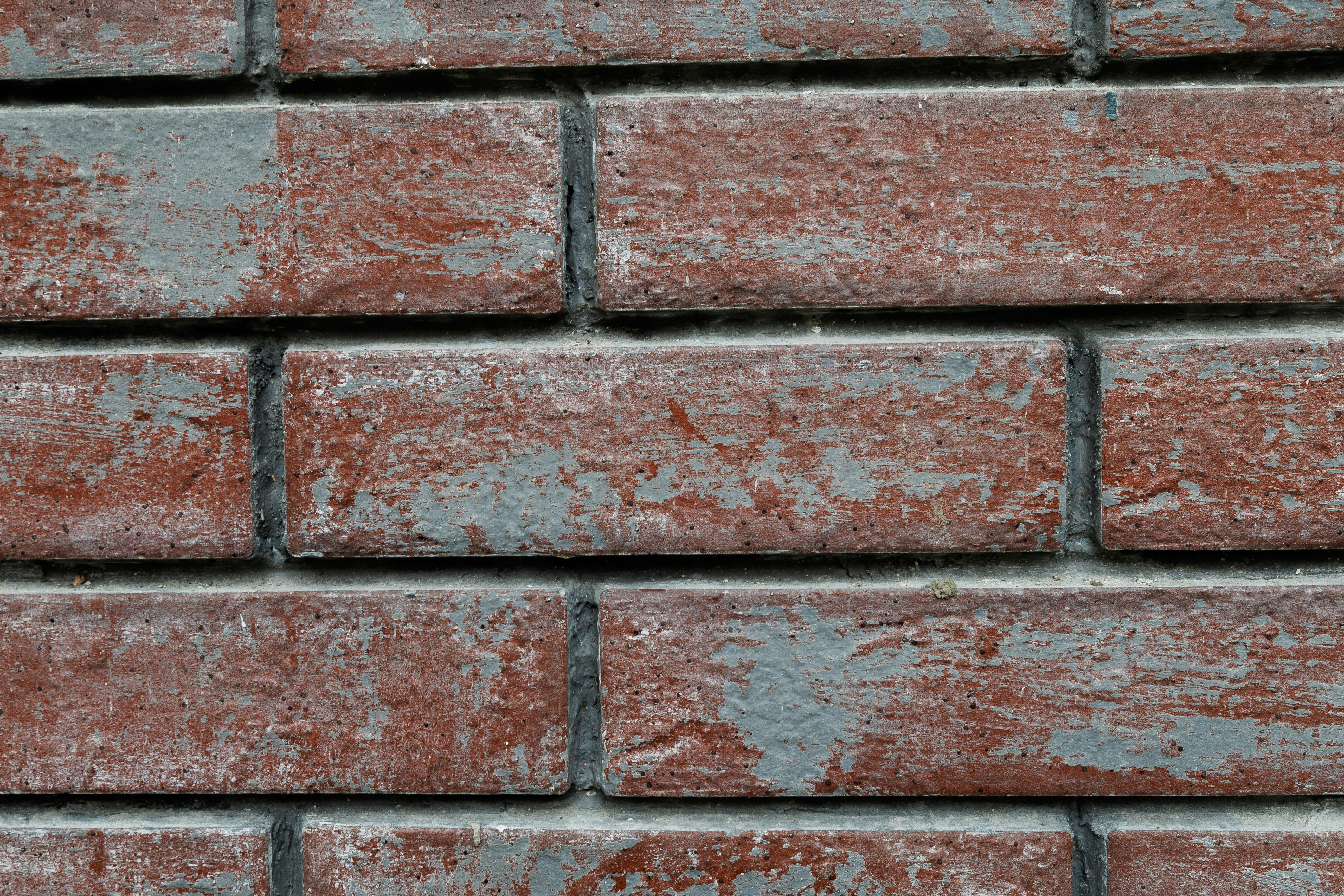 Free Detailed closeup of a textured red brick wall with weathered appearance. Stock Photo