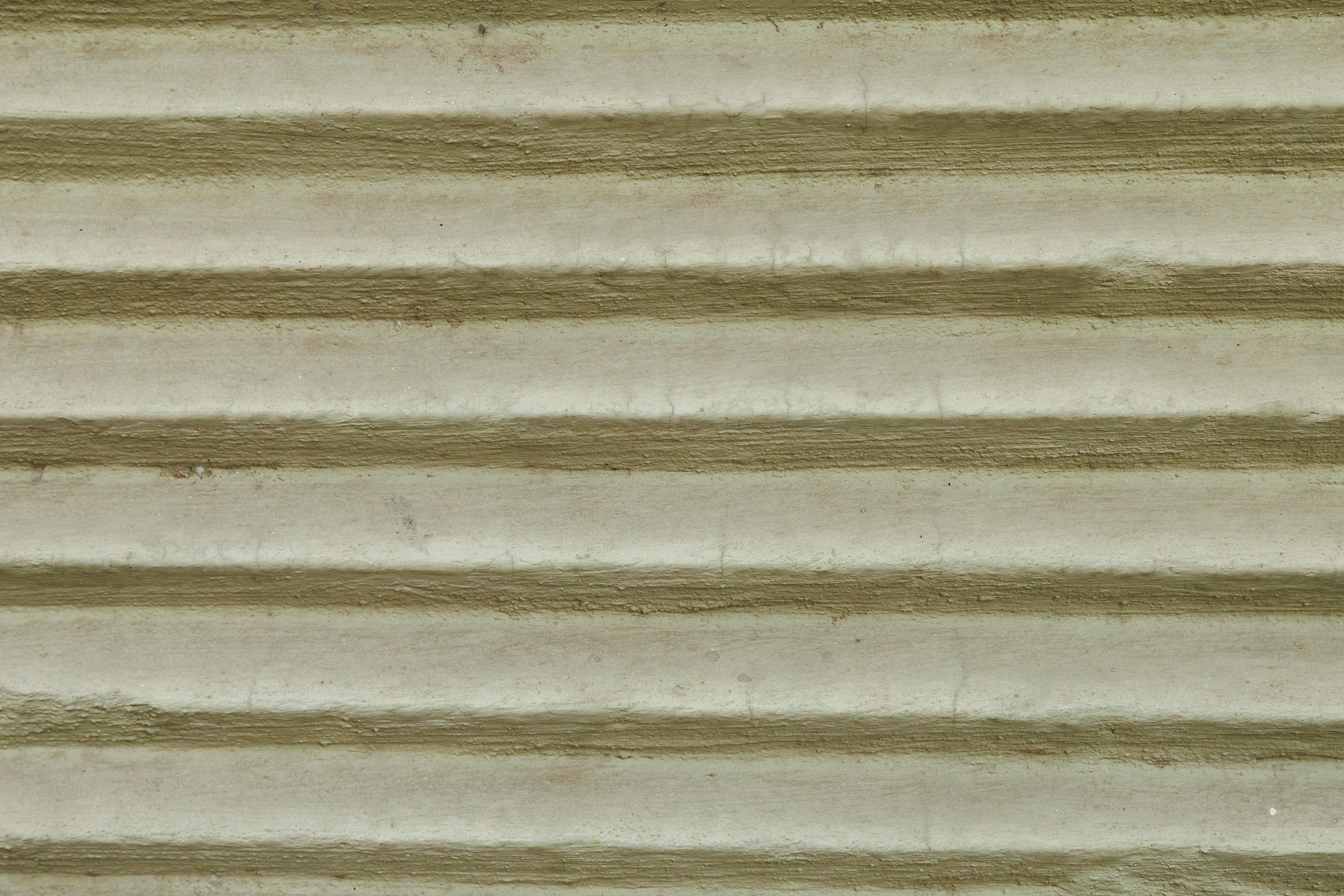 gratis Detailopname van een wand van gegolfd metaal met een gestructureerd patroon van parallelle lijnen. Stockfoto