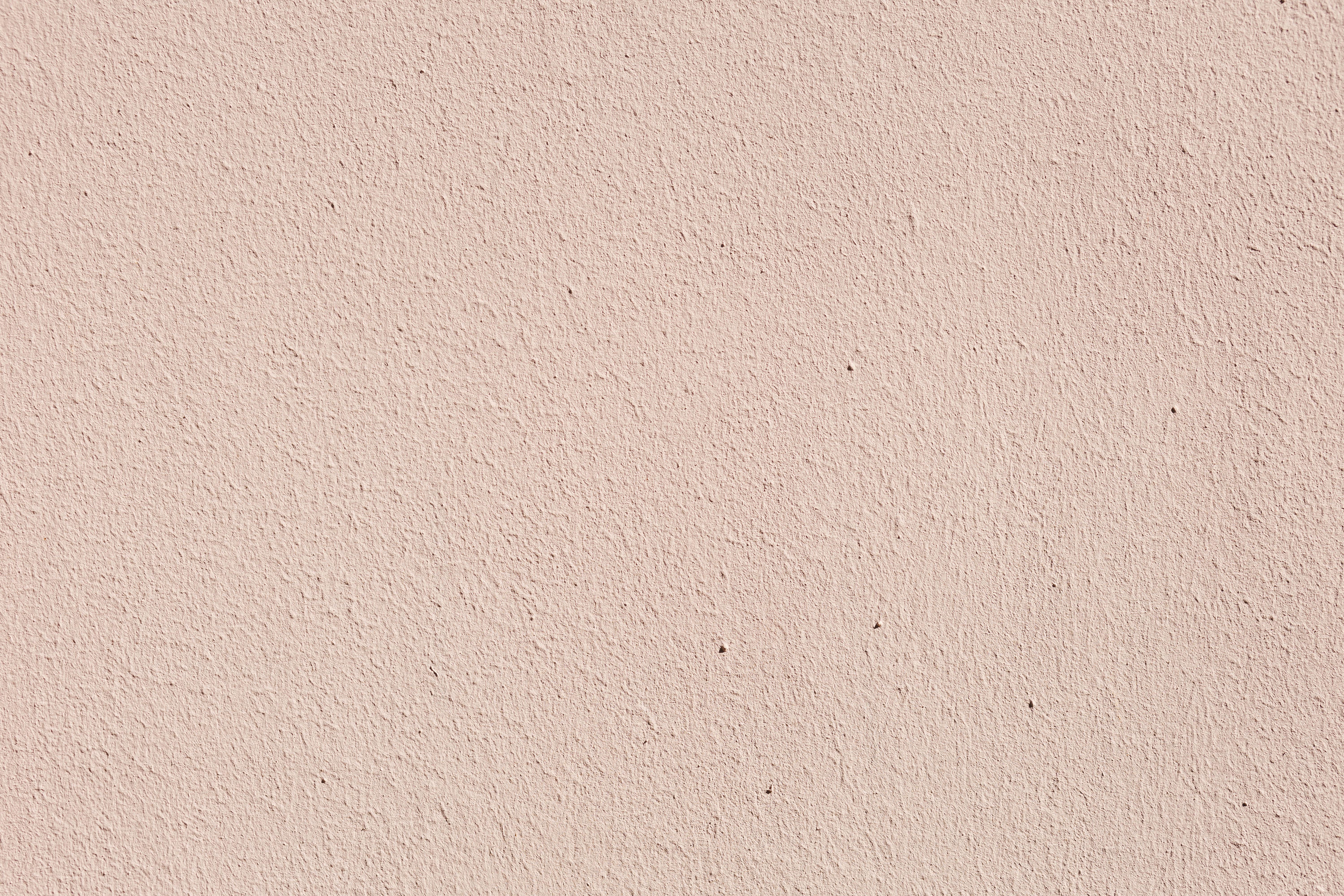 Free Close-up of a pink plaster wall with subtle texture, ideal for backgrounds. Stock Photo