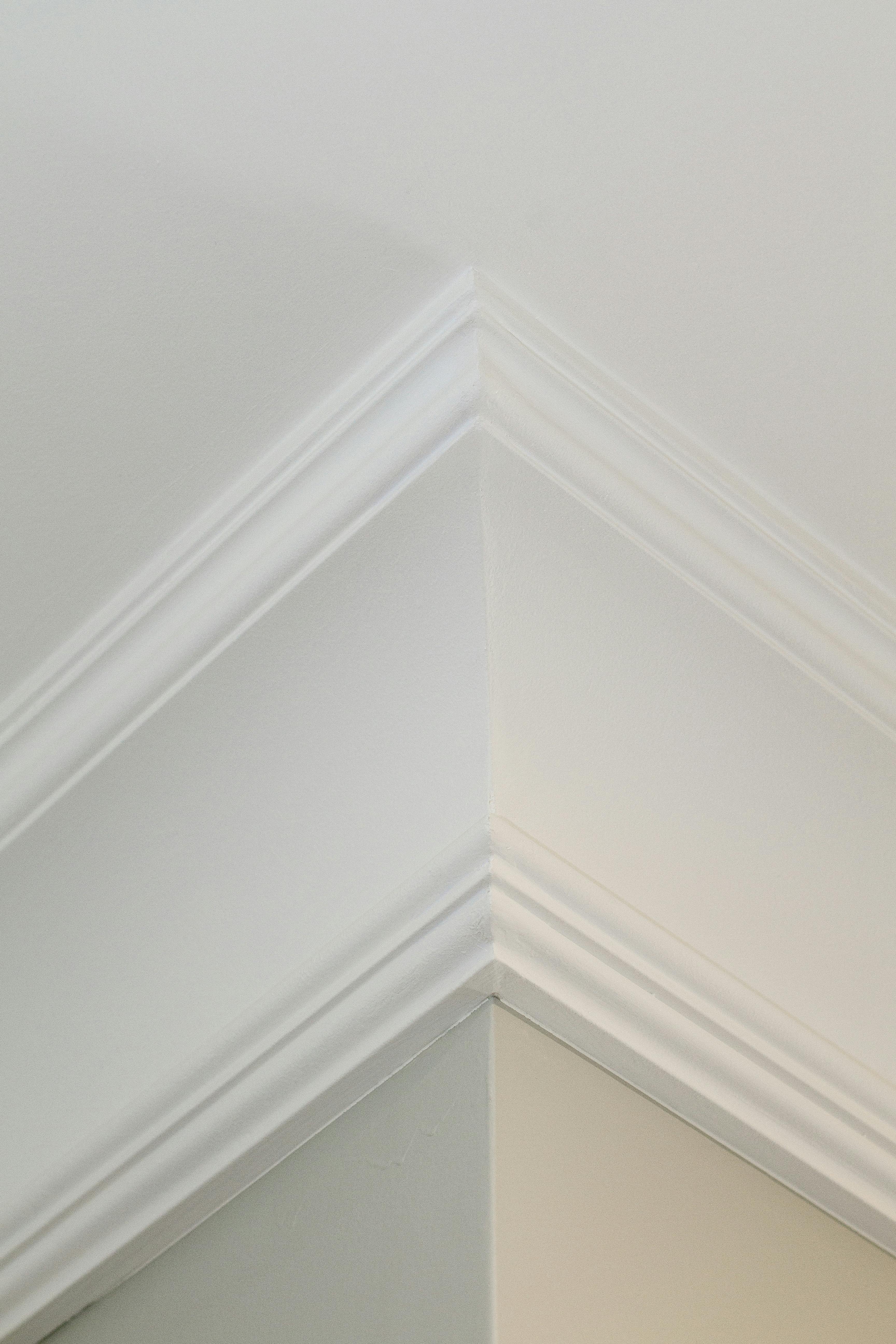 Free Close-up of elegant white ceiling molding in a modern interior. Stock Photo