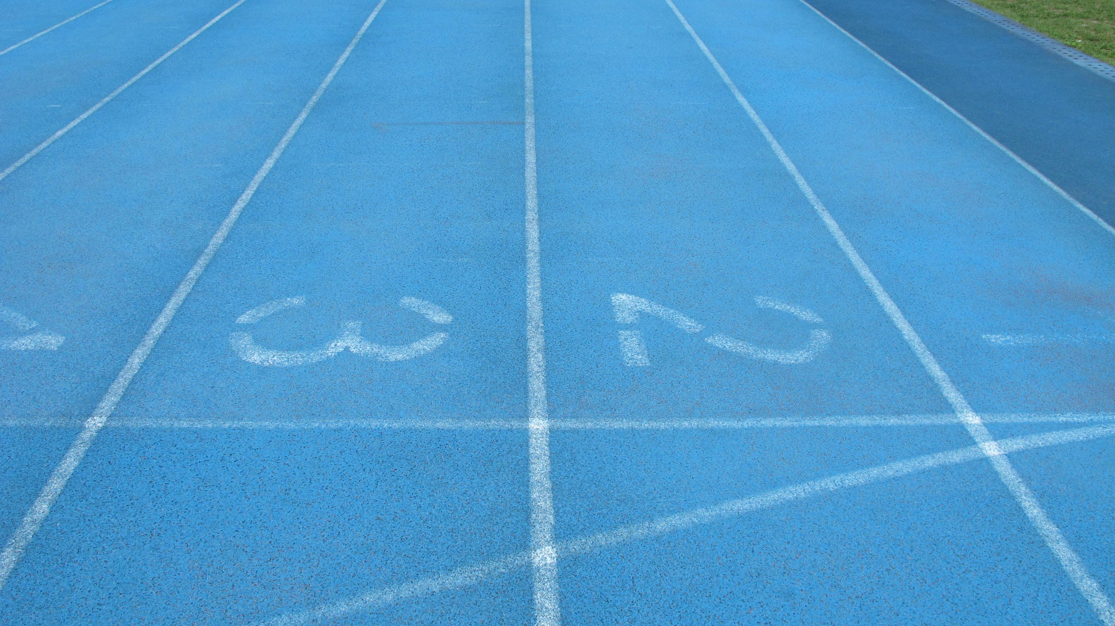 Δωρεάν Κοντινή άποψη ενός μπλε στίβου με λευκούς αριθμούς και σημάνσεις λωρίδων. Φωτογραφία από στοκ φωτογραφιών