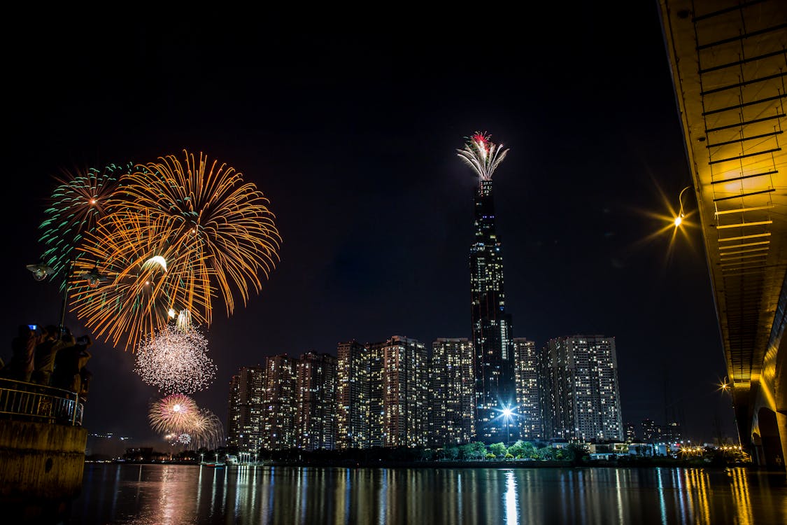 Fireworks Display Over City Buildings During Night Time