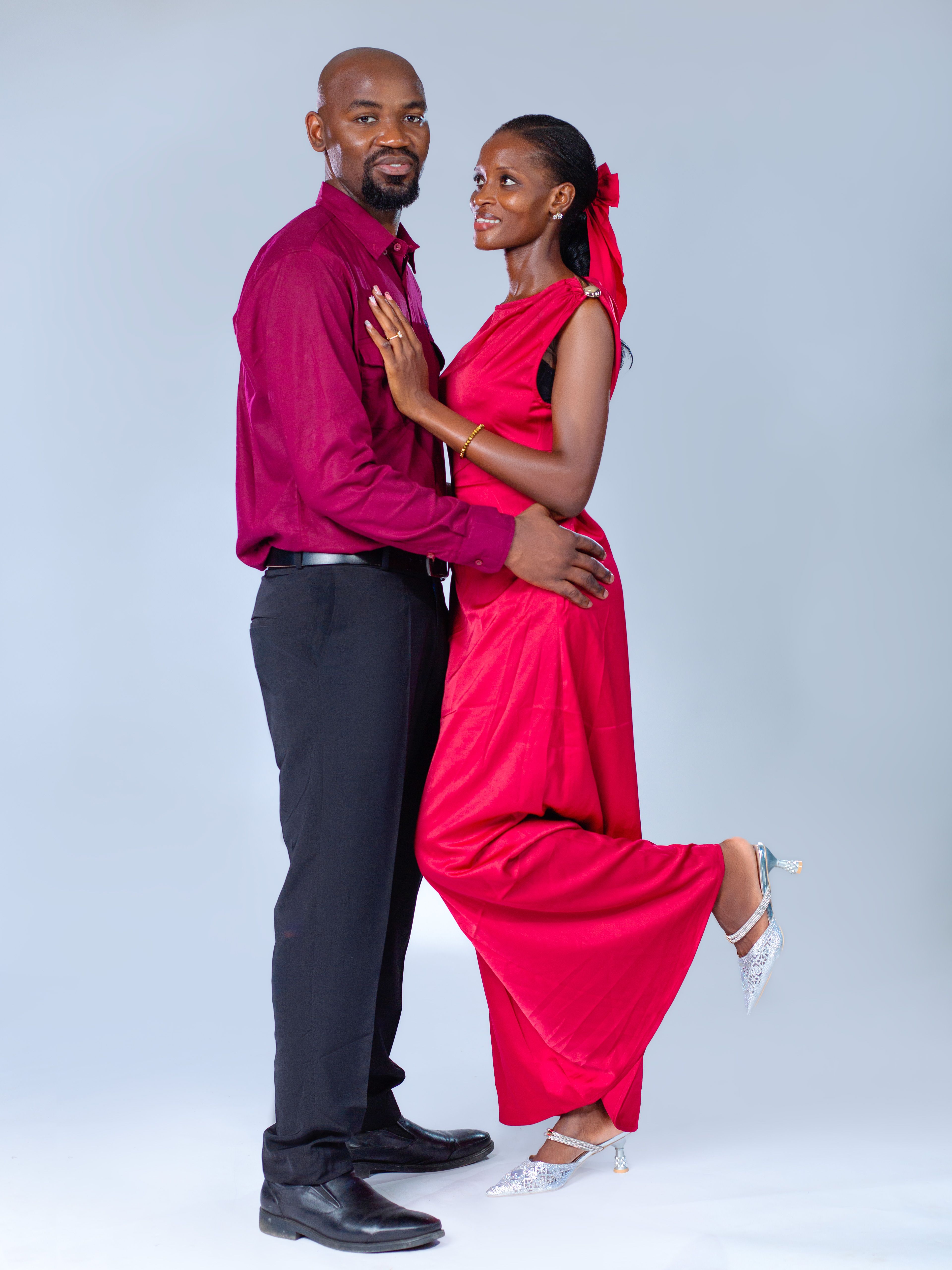 Elegant Couple in Formal Red Attire Posing · Free Stock Photo