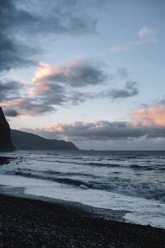 Stunning coastal view of Madeira's cliffs and ocean at sunset.