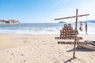 Coastal Beach Scene with Sign and Mounted Fish