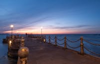 Serene Pier Sunset with Soft Ocean Waves