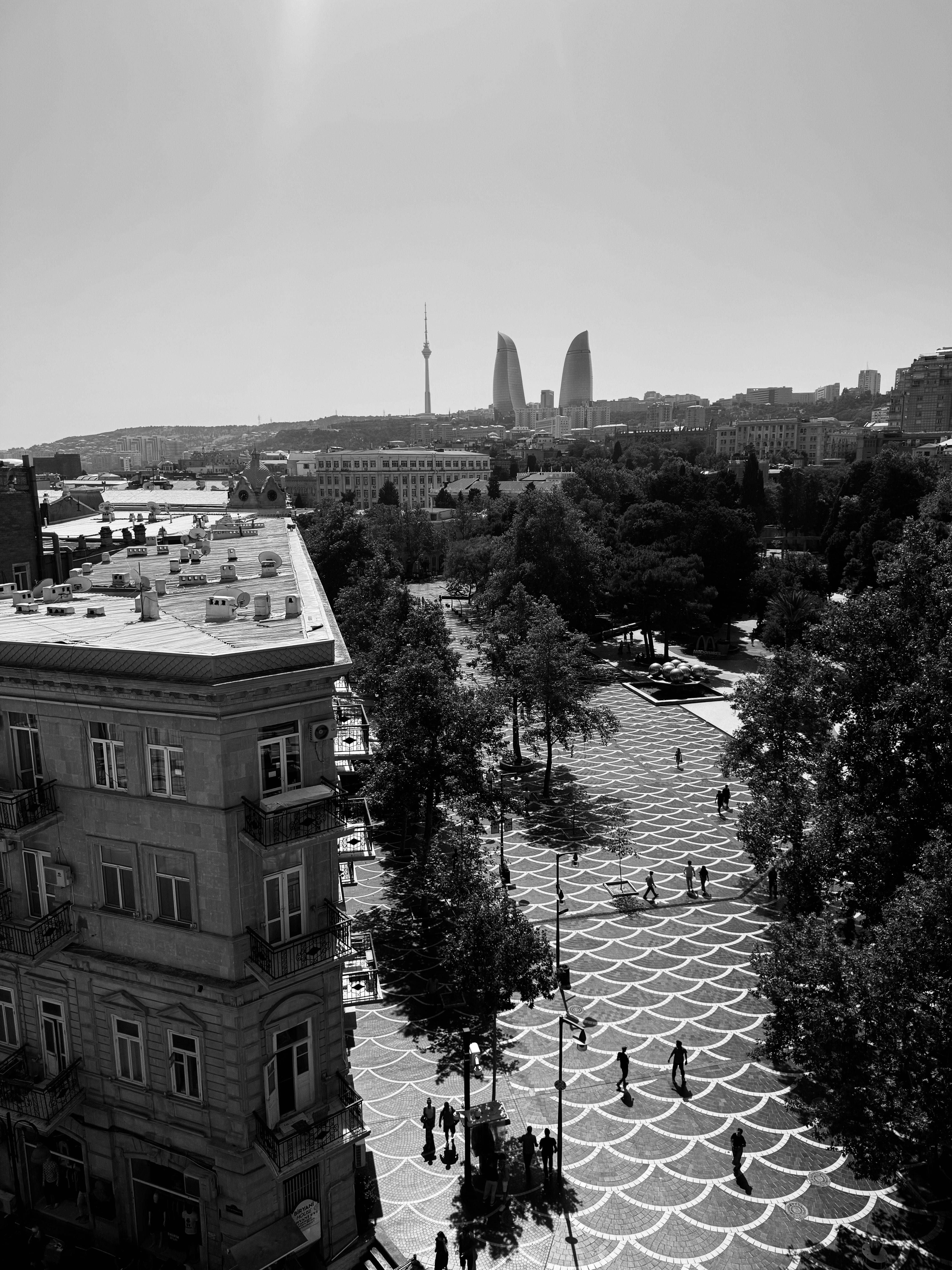 Monochrome aerial photo of Baku, Azerbaijan, showcasing Flame Towers and urban landscape.