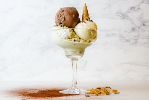 A delicious ice cream dessert with multiple flavors in a glass, perfect for summer.