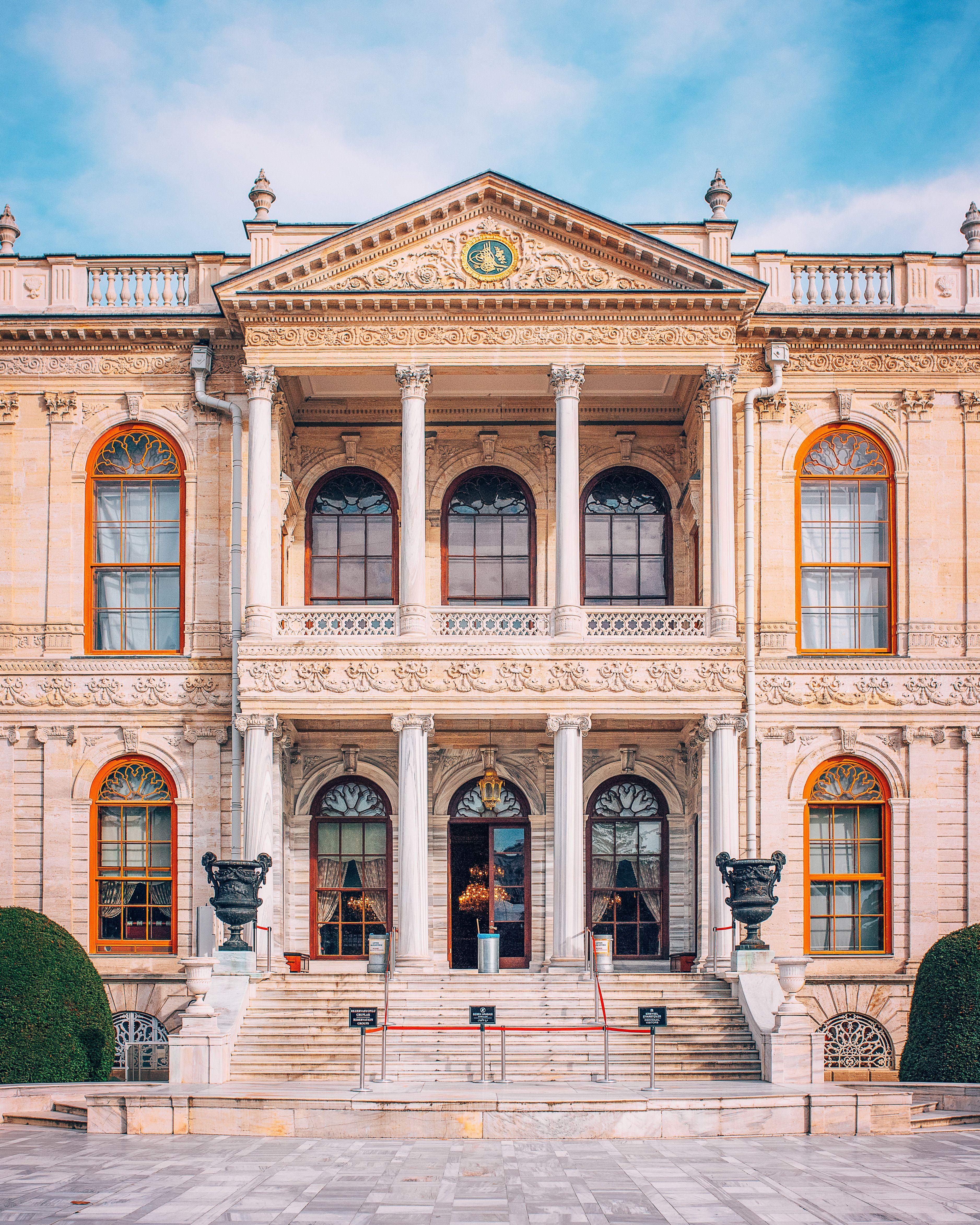 Elegant Neoclassical Mansion Facade Under Blue Sky · Free Stock Photo