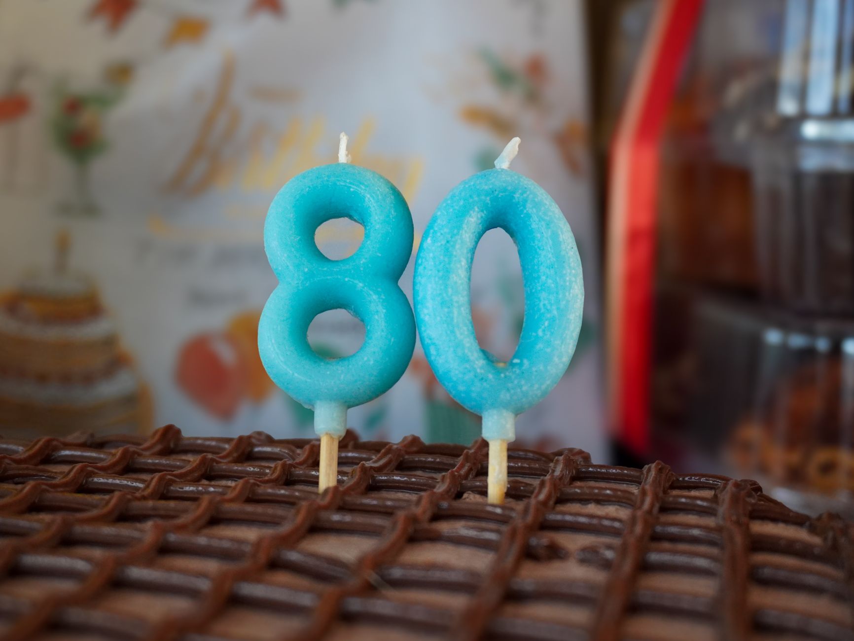 Blue number candles on an 80th birthday cake, perfect for celebratory occasions.