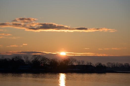 Captivating winter sunrise at Cove Island Park, Stamford, Connecticut with serene waters reflecting the sun.