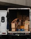 Delivery worker organizing boxes in truck