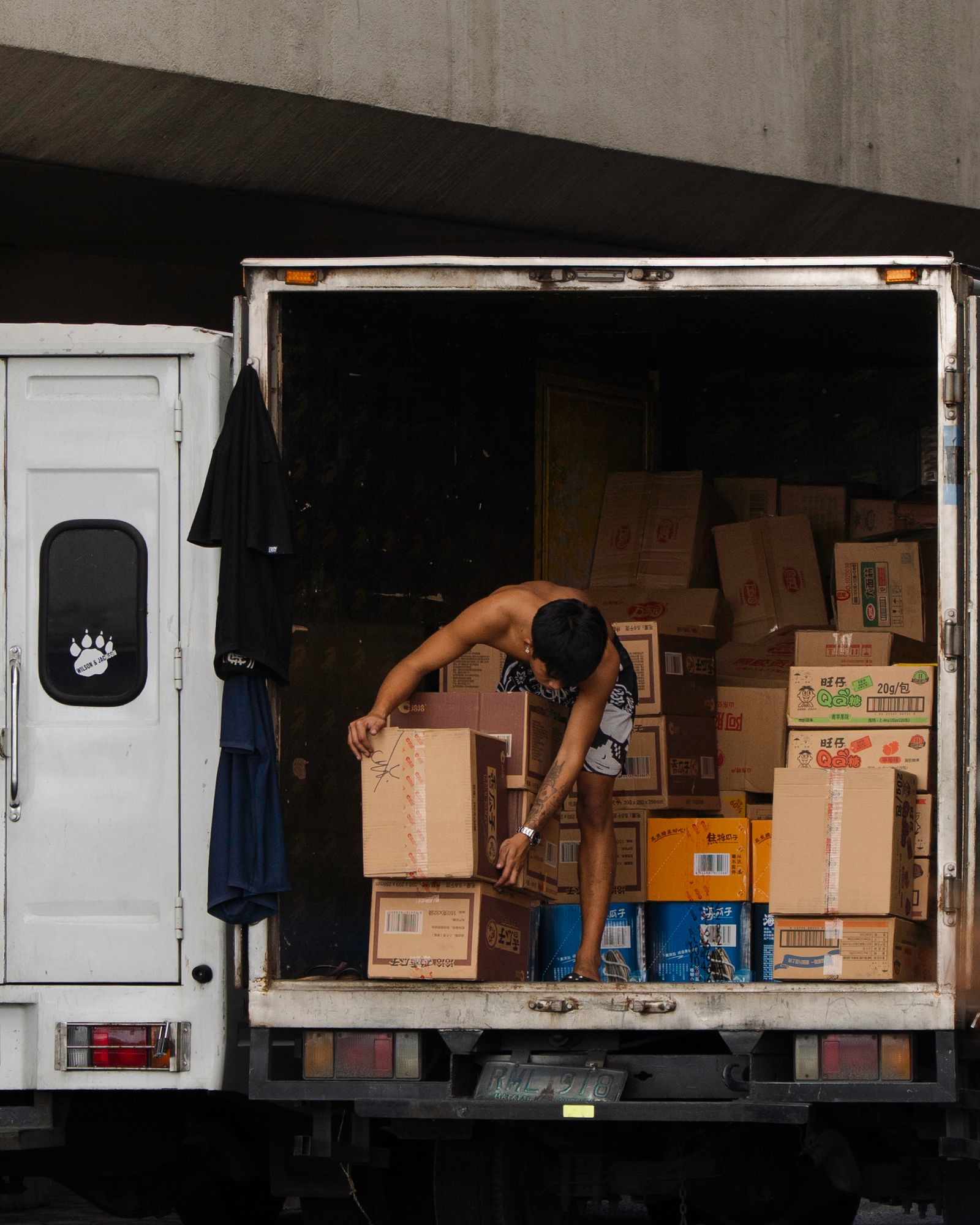 Delivery worker organizing packages inside a transport vehicle
