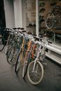 White and Brown City Bikes Parked Beside Glass Window