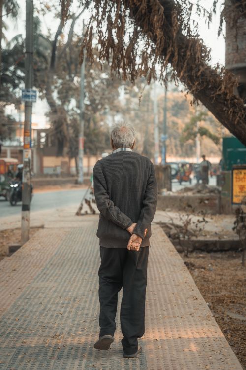 Free Elderly South Asian man strolling on a city sidewalk in Cumilla, Bangladesh. Stock Photo