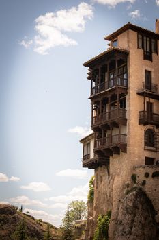 Stunning view of the iconic Hanging Houses in Cuenca, Spain, under a clear blue sky.