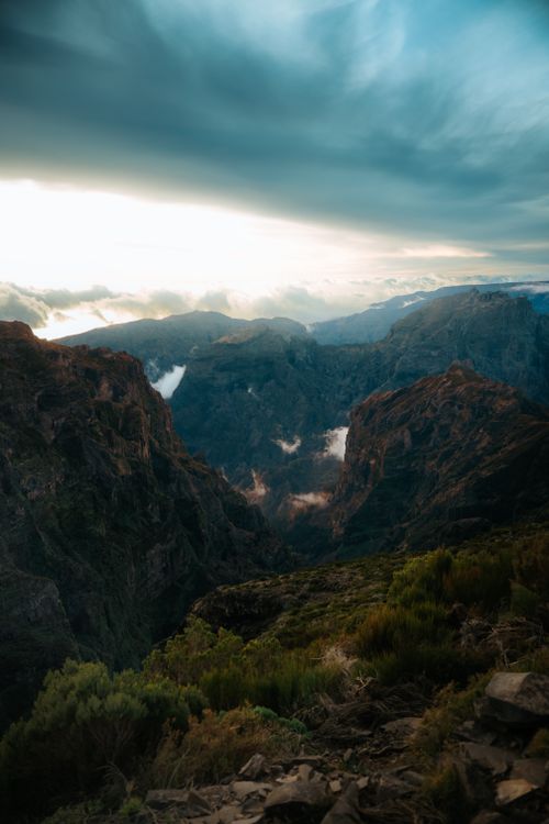 Free Scenic view of Madeira's dramatic mountains and clouds at sunrise. Stock Photo