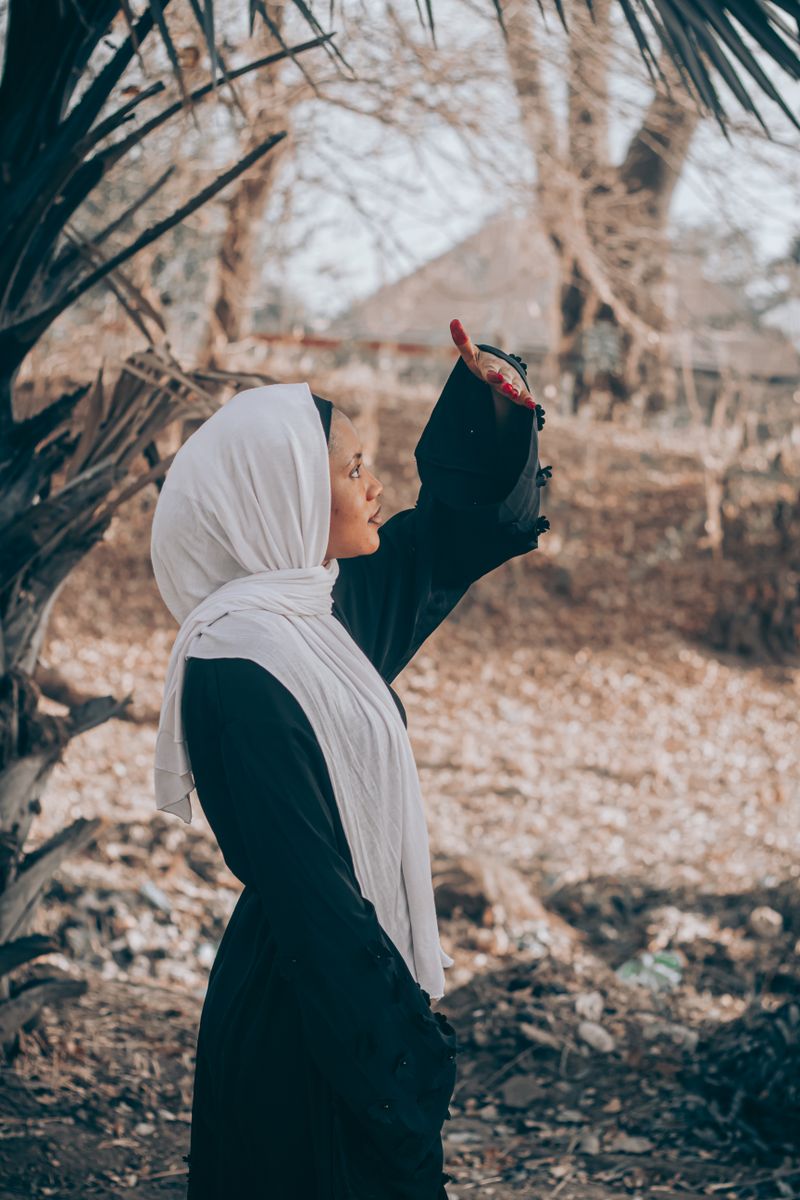 Woman in Hijab Walking at Sunset · Free Stock Photo