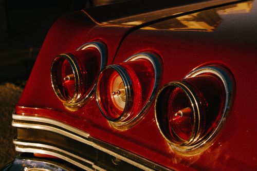 Free Retro car tail lights shining under warm evening sun in Torrevieja, Spain. Stock Photo