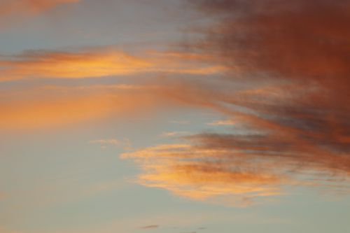 Free A stunning sunset featuring vibrant orange and blue clouds creating a dramatic sky. Stock Photo