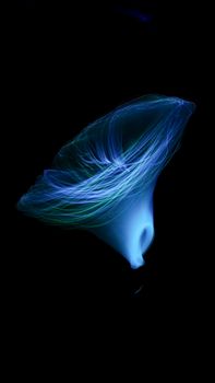 Captivating abstract blue light effect resembling ethereal motion on a dark background.