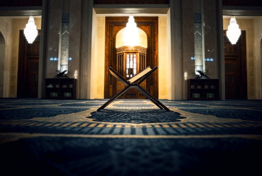 A beautifully lit Quran stand inside a mosque in Kuwait City, showcasing Islamic architectural details.