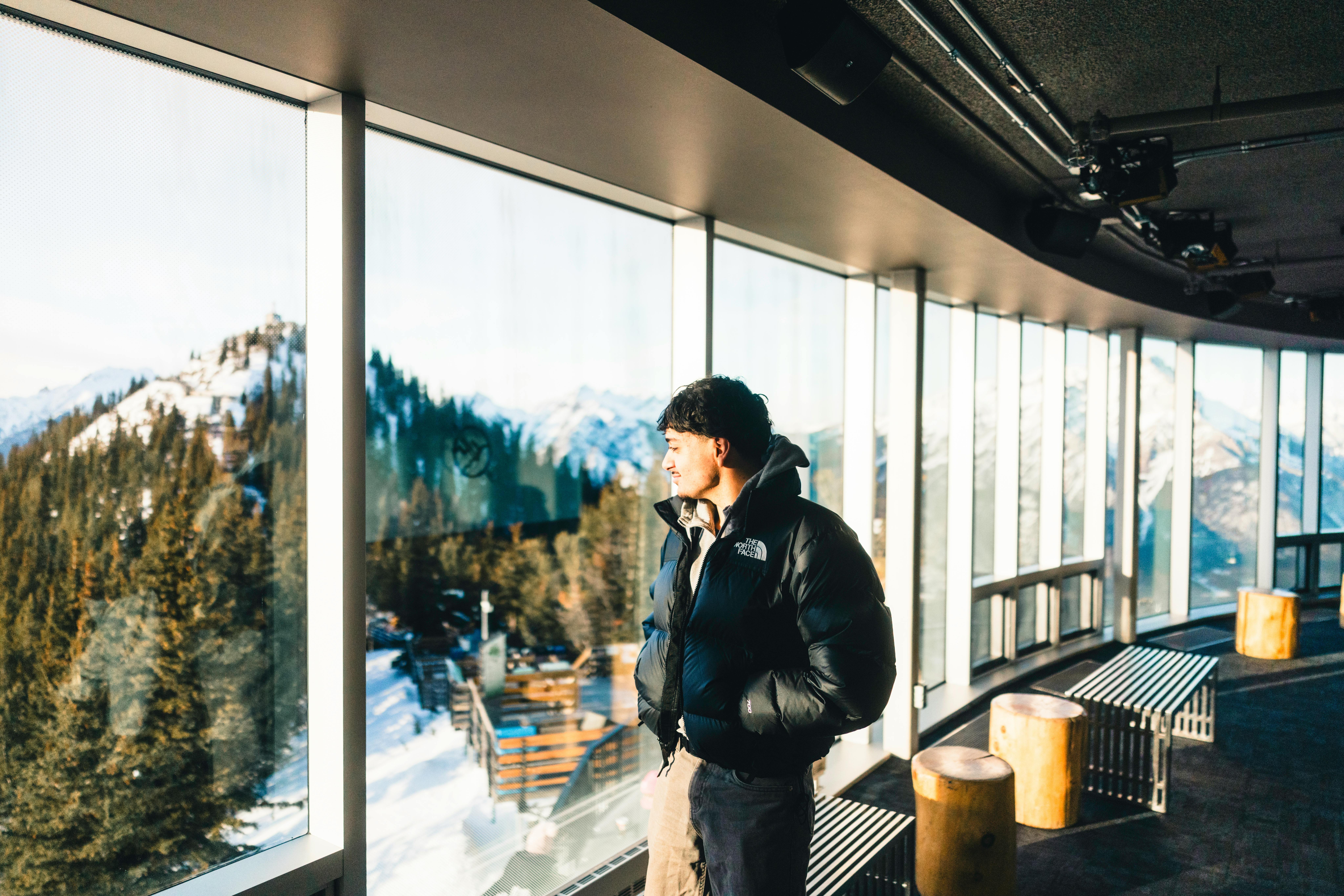 gratis Een man geniet van het schilderachtige winterse berglandschap vanuit de Banff-gondellift in Alberta, Canada. Stockfoto