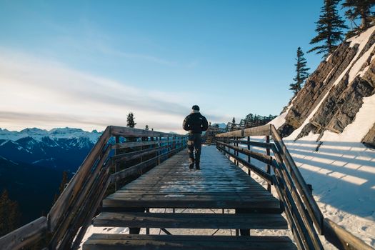 A traveler explores the snowy pathways in Banff National Park, Alberta, Canada.