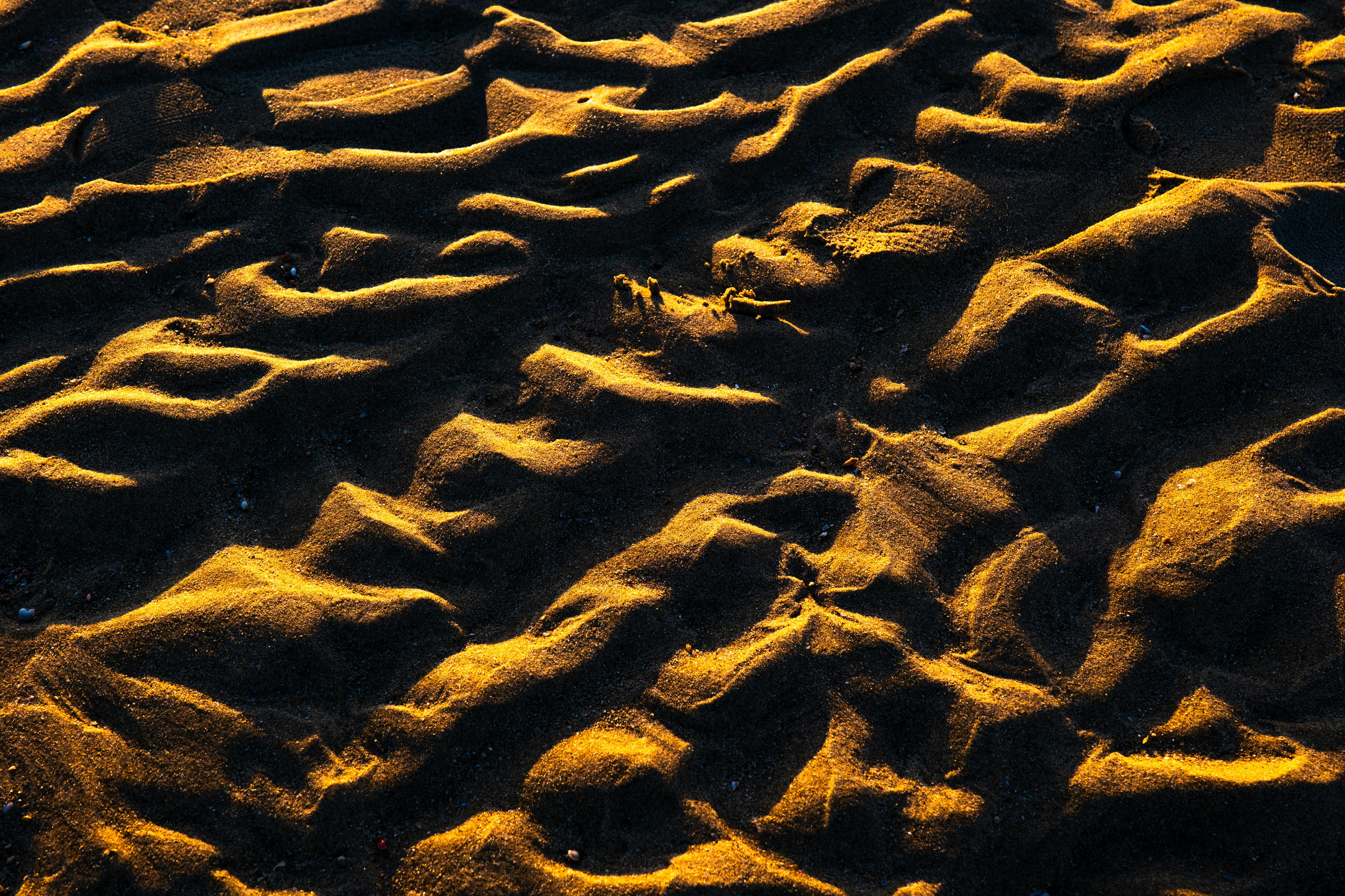 Free Abstract patterns of beach sand dunes captured with golden sunset lighting in Kuwait. Stock Photo