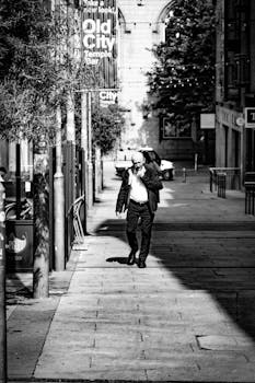 Moody black and white photo of a man walking in Temple Bar, Dublin.