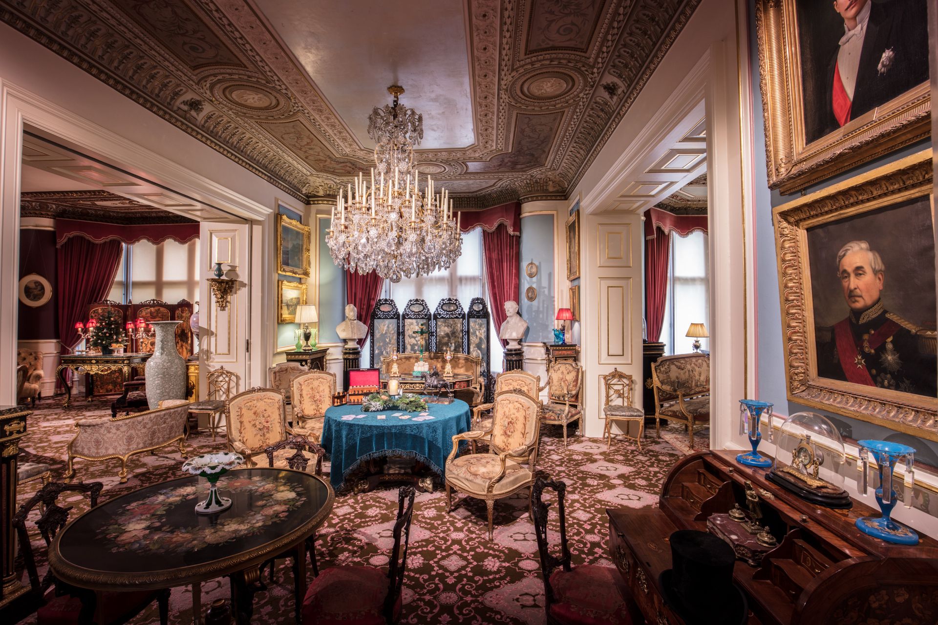 A beautifully decorated historic drawing room featuring opulent furnishing and architectural details