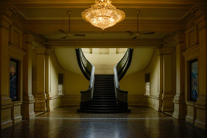 Grand staircase beneath a chandelier — photo by Thái Phát on Pexels