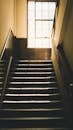 Moody Staircase with Sunlit Window