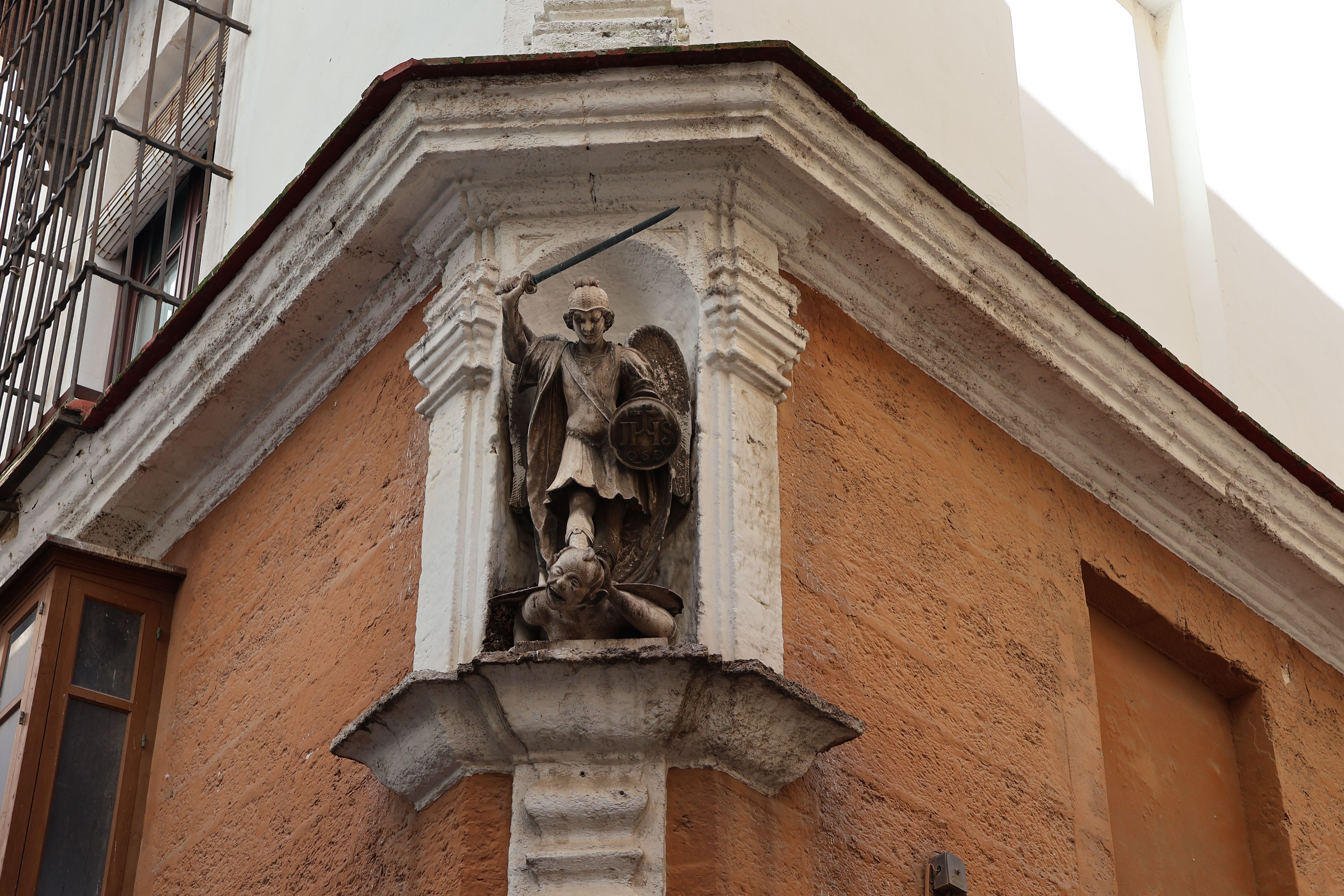 Historic statue of St. Michael the Archangel in a Cádiz street corner. Captured authentically.