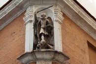 Detailed view of St. Michael Archangel statue on a historic building in Cádiz, Spain.