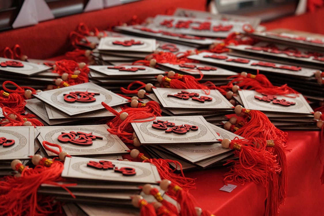 Free White and Red Lucky charm on Red Table Stock Photo