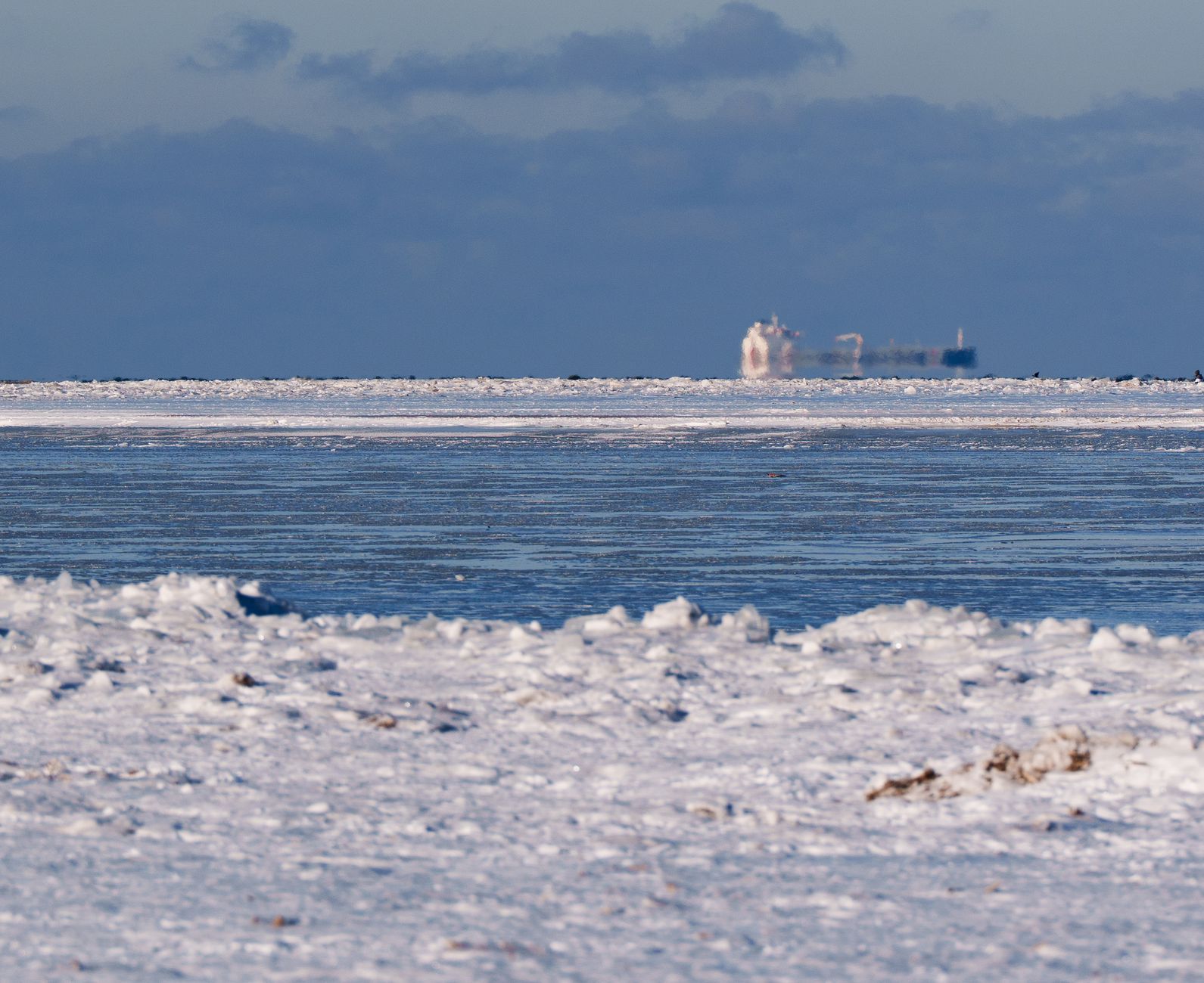 A cargo ship navigates through Arctic sea ice, illustrating the kind of conditions faced on Northern Sea Route voyages.
