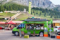 Bright Green Coffee Truck in Mountainous Landscape