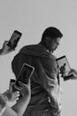 Stylish Man Surrounded by Smartphones