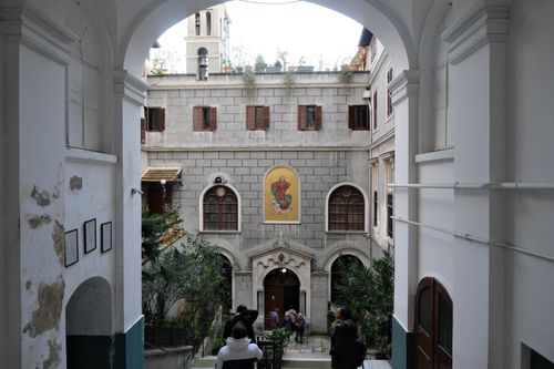 Free A serene look at a historic courtyard with a bell tower and religious architecture. Stock Photo