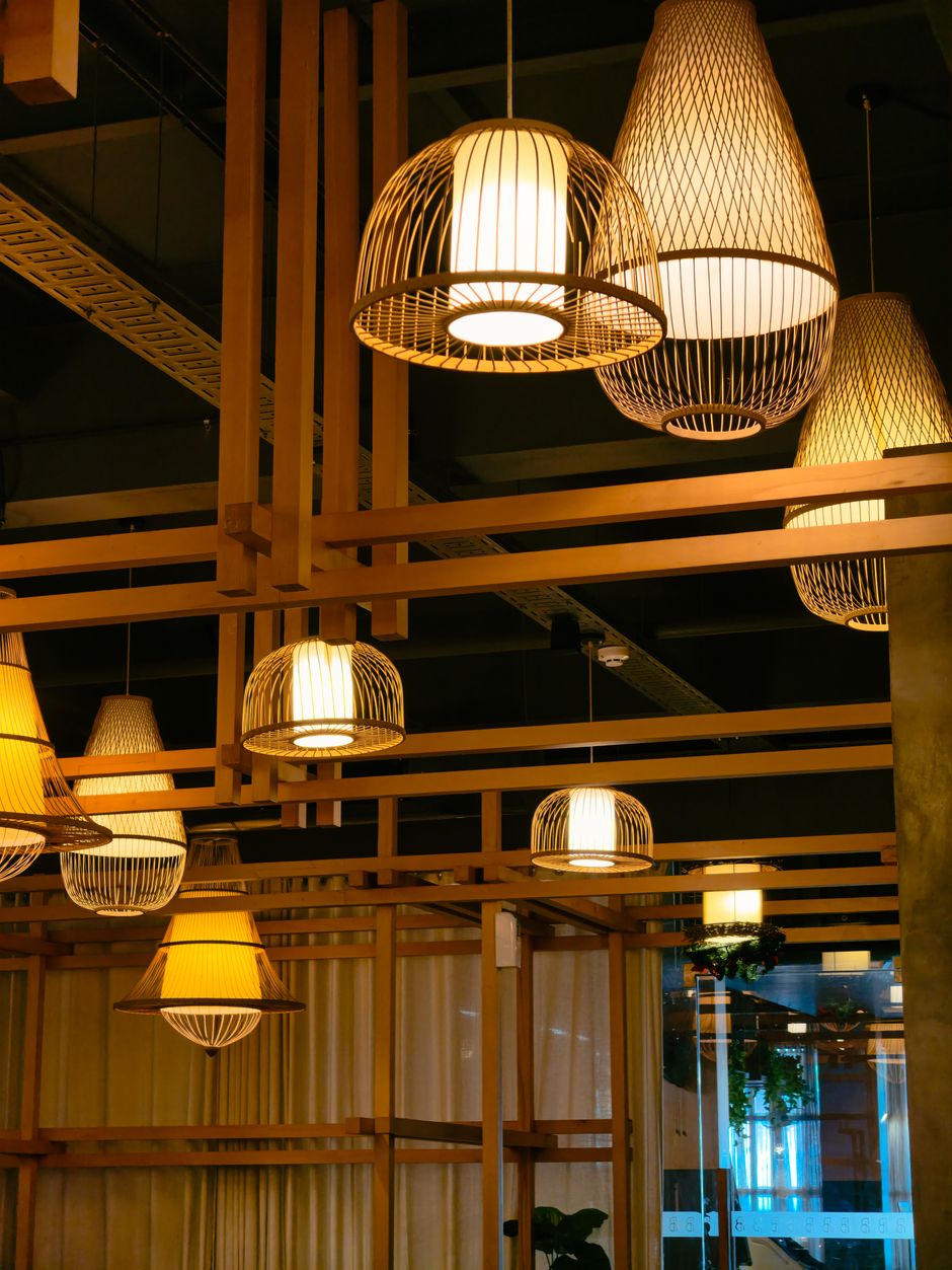 Elegant ceiling lamps with wooden frames in a modern indoor setting.