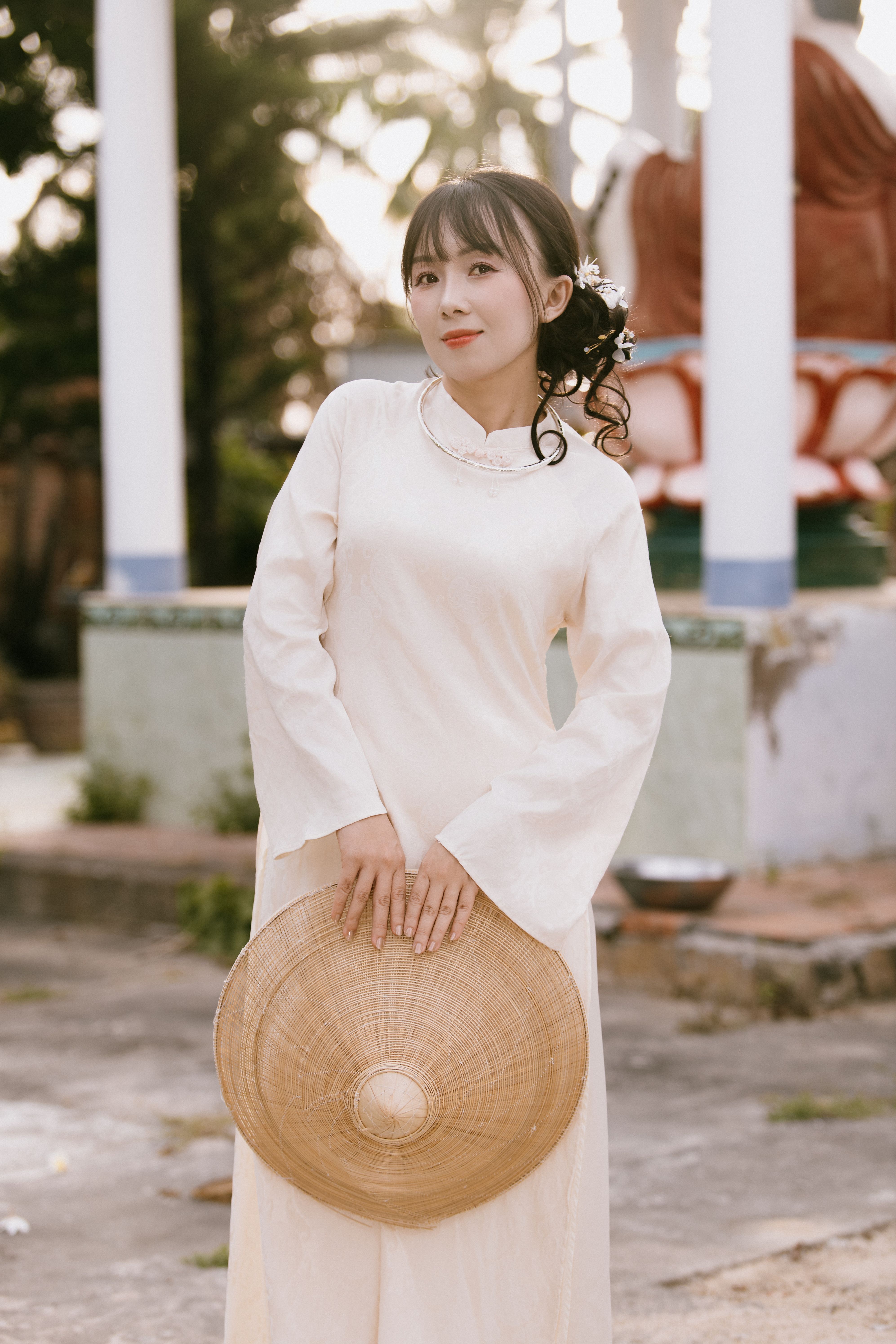 Young Woman in Traditional Dress Holding Straw Hat · Free Stock Photo