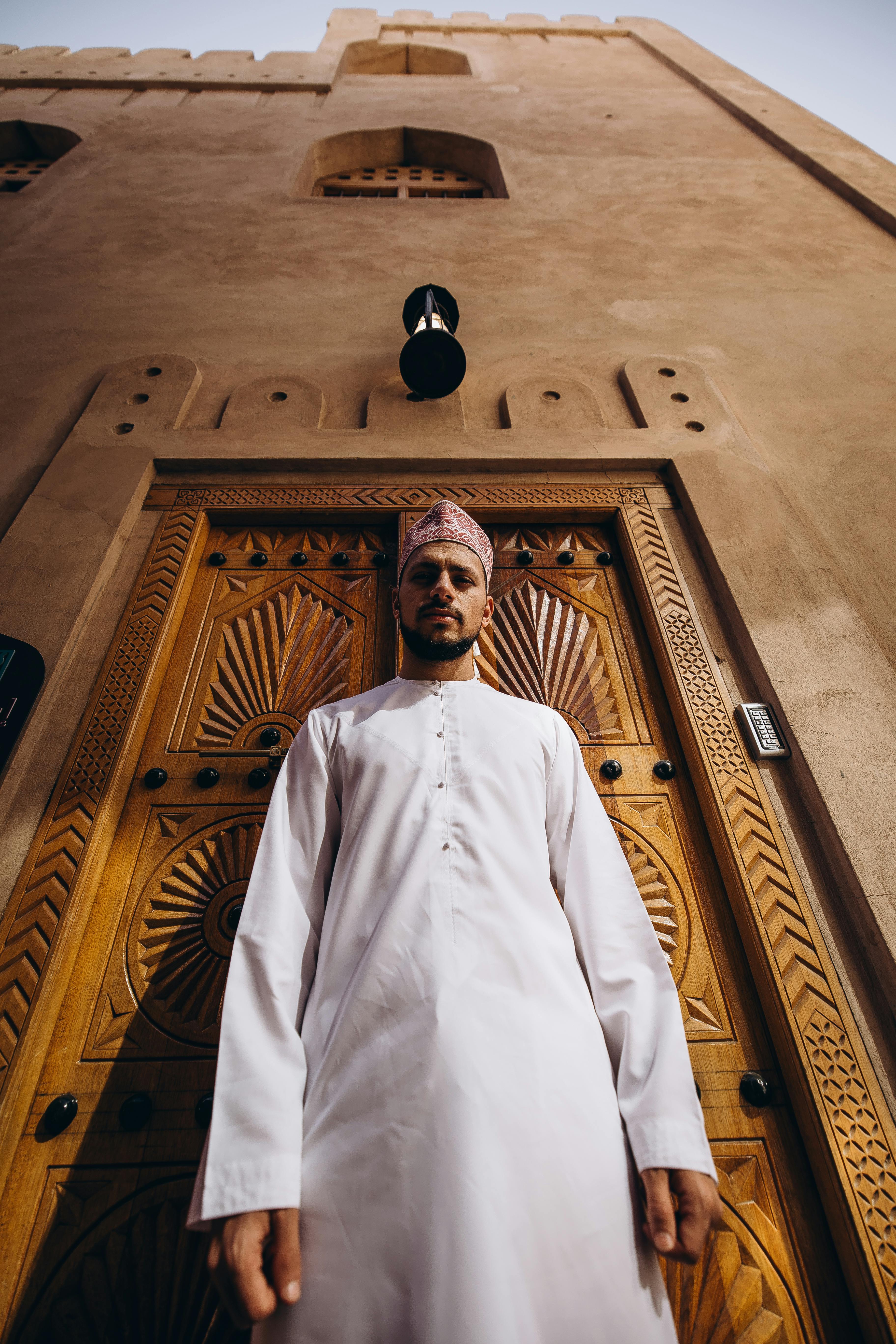 Experience the rich heritage of Oman with traditional attire and architecture on display.
