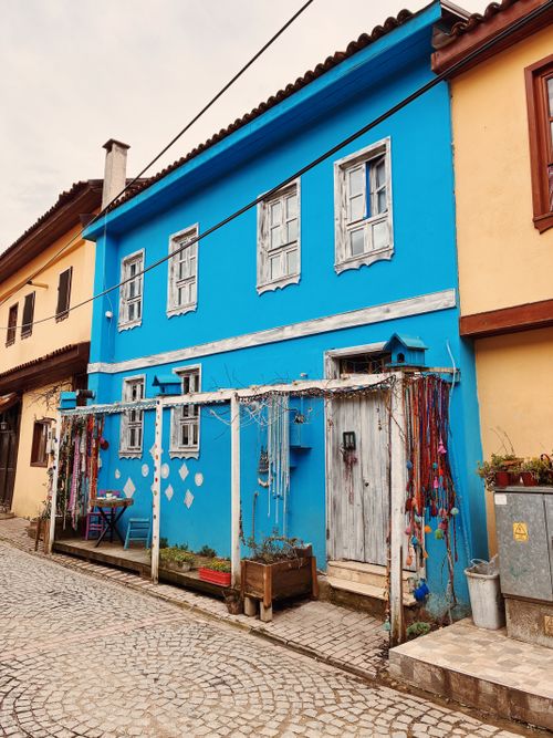 Free A colorful blue house in Bursa, Türkiye displaying hanging decorations, showcasing local architecture and culture. Stock Photo