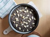 Top view of a homemade almond and poppy seed cake in a pan, perfect for dessert enthusiasts.