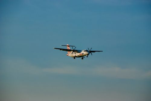 Free An ATR 72 airplane captured in flight approaching landing in a clear blue sky over Warsaw, Poland. Stock Photo