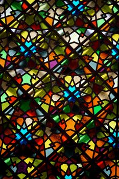 Colorful geometric stained glass pattern with vibrant hues photographed in İstanbul, Türkiye.
